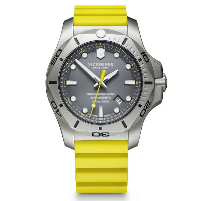 A stainless steel Victorinox dive watch with a gray dial, white markers, and a yellow rubber strap, shown face up.