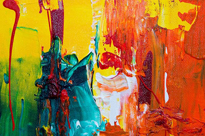 Abstract painting with bold streaks of yellow, green, red, blue, and white paint blending and dripping across the canvas.